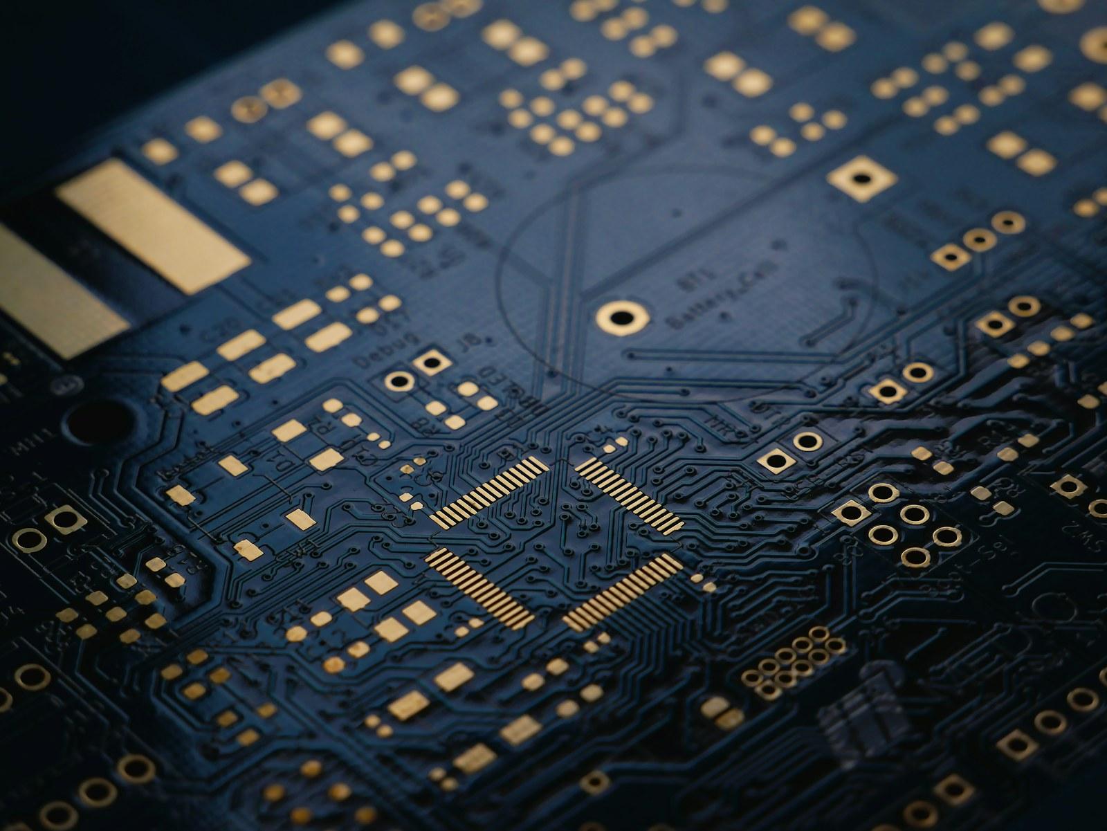 Close-up of a dark blue circuit board with gold contacts